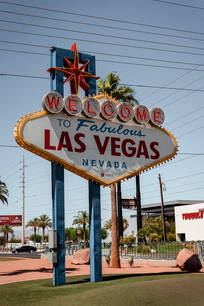 Modern colorful signboard with inscription welcome to fabulous Las Vegas Nevada state in USA placed on green lawn on sunny day